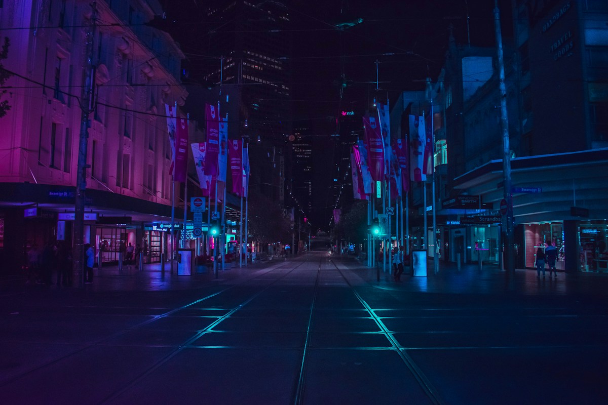 A neon-lit city street at night